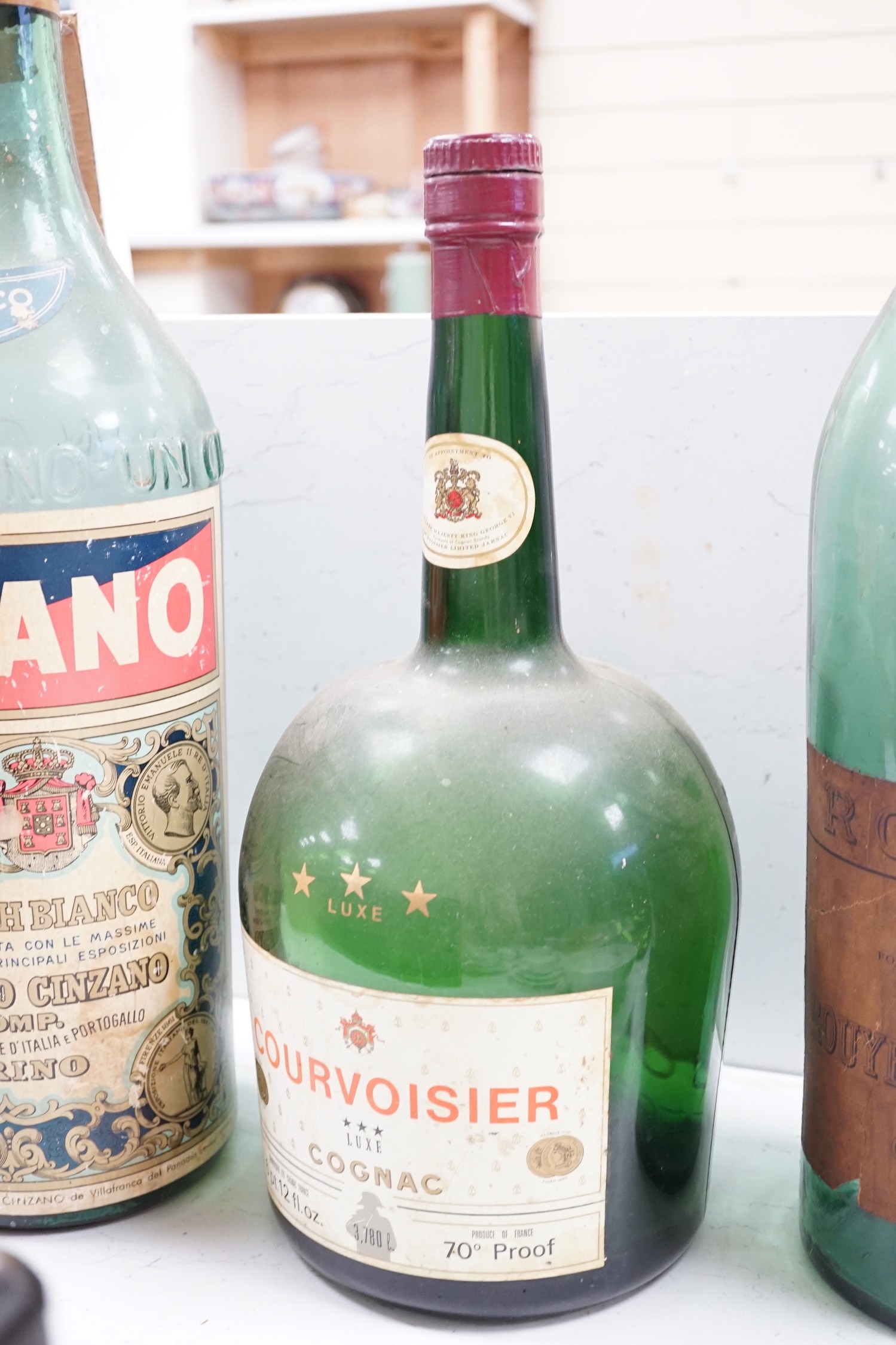 A collection of oversize and advertising bottles for Cinzano, Courvoisier, Moet Chandon, Rouyer Guillet cognac, Grand Opera cognac and Chateau Coufran, largest 52 cm